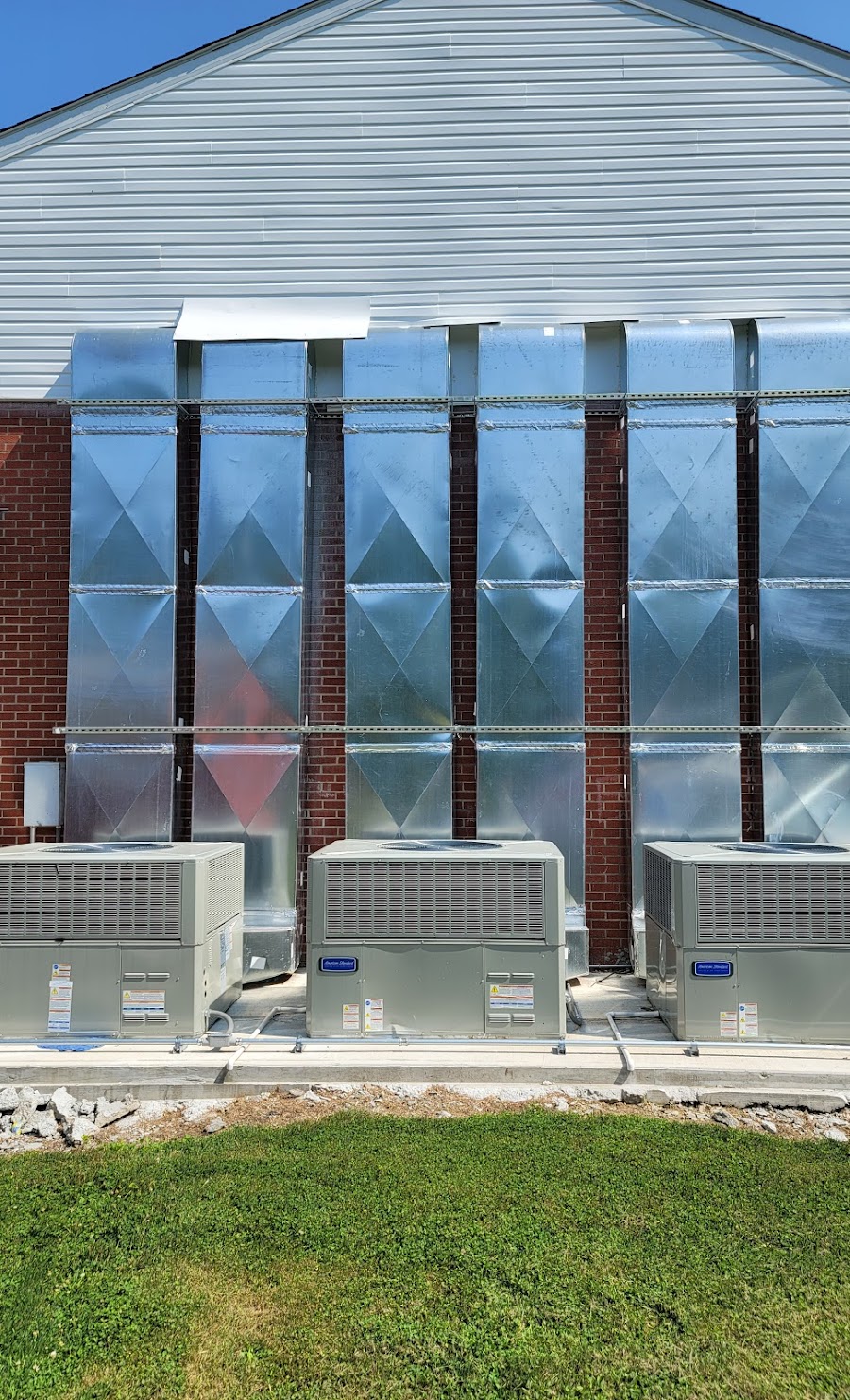 Three American Standard commercial package units installed against a brick building in Laurel County, KY