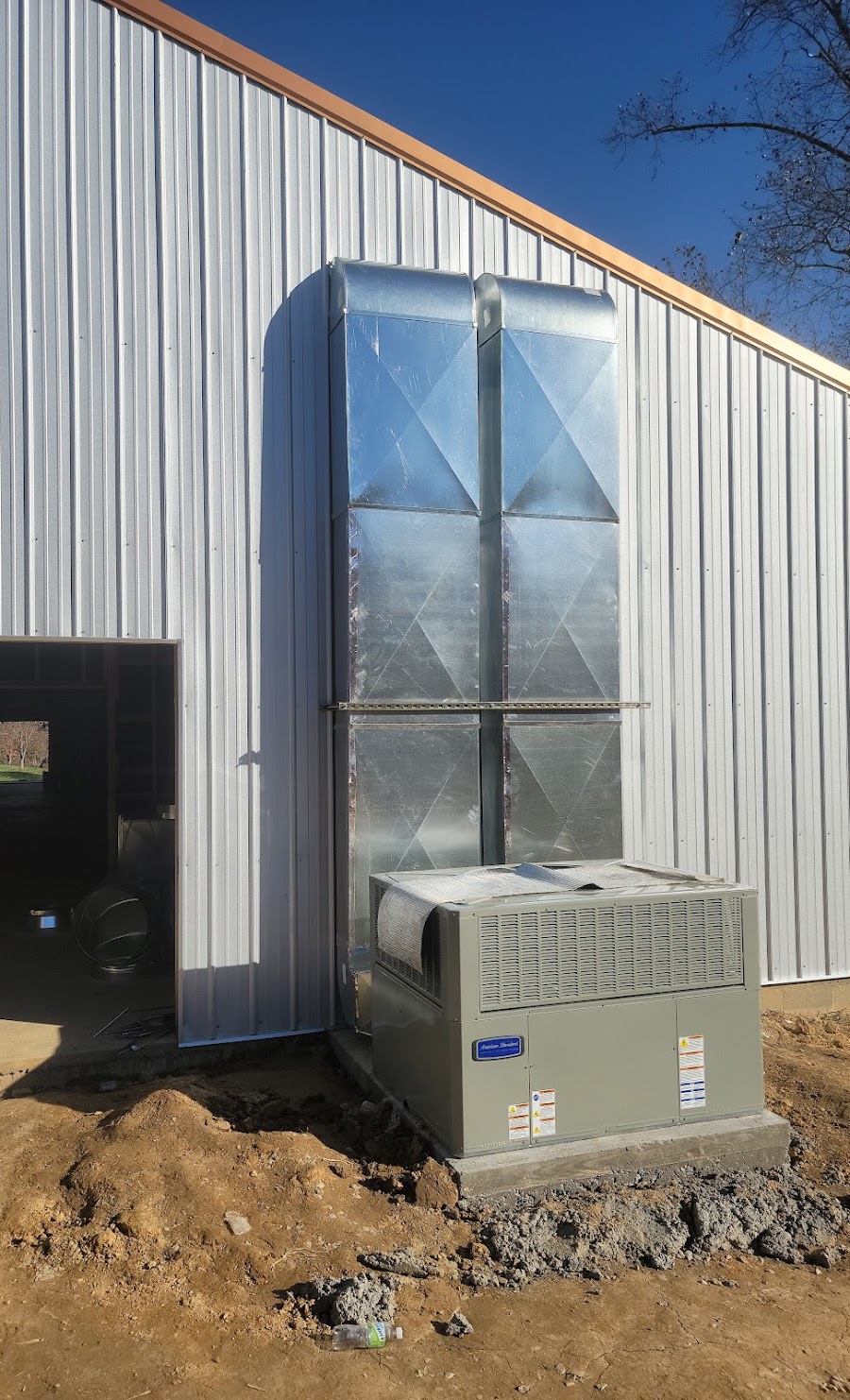 American Standard package unit with custom sheet-metal duct work on a metal building